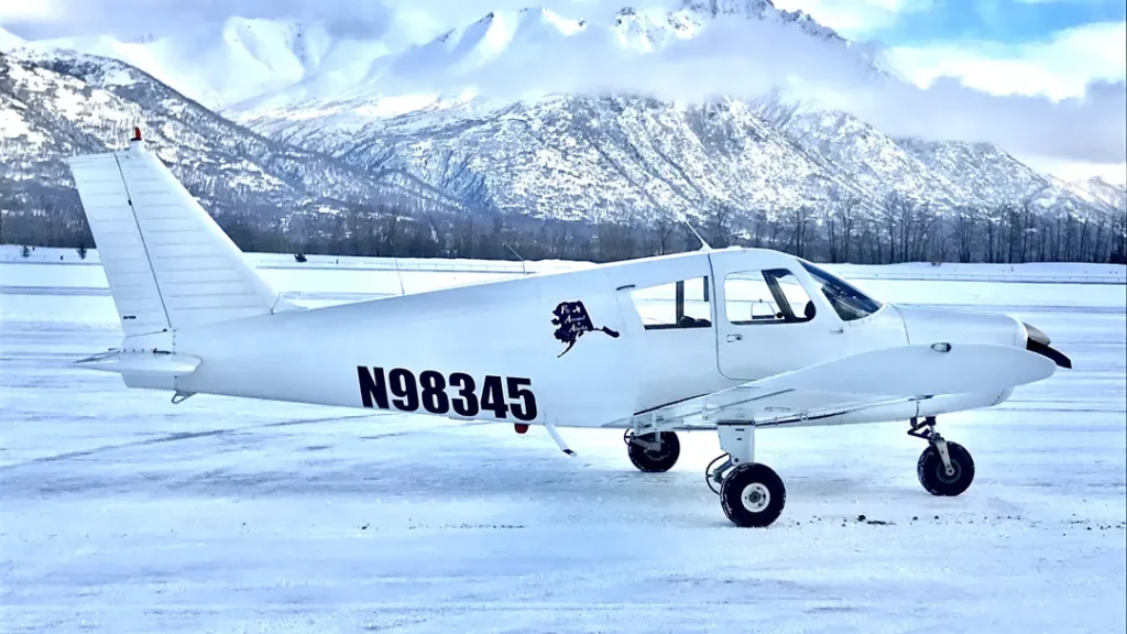 fly around alaska white airplane with alaskan landscape during winter