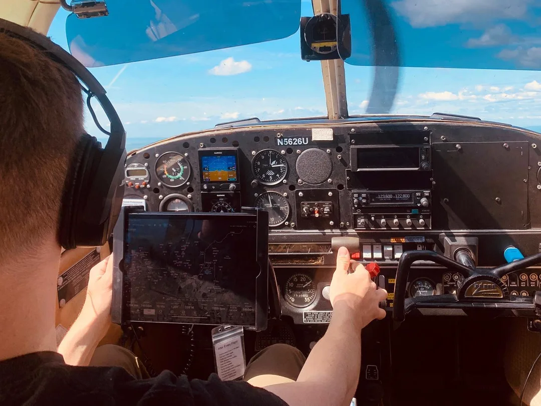 accellerated flight training program pilot in plane clear view of ipad